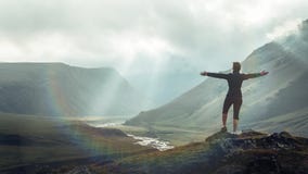 Discovery Travel Destination Concept. Hiker Young Woman With Backpack Rises To The Mountain Top Against Backdrop Of Sunset, Rear royalty free stock photo Discovery Travel Destination Concept. Hiker Young Woman With Backpack Rises To The Mountain Top Against Backdrop Of Sunset, Rear royalty free stock photo