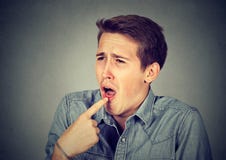 Disgusted man with finger in mouth displeased ready to throw up royalty free stock photography Disgusted man with finger in mouth displeased ready to throw up royalty free stock photography