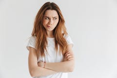 Displeased woman in t-shirt with crossed arms looking away Royalty Free Stock Images Displeased woman in t-shirt with crossed arms looking away Royalty Free Stock Images