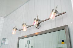 Dispositivos elétricos de iluminação no banheiro sobre um espelho foto de stock Dispositivos elétricos de iluminação no banheiro sobre um espelho foto de stock