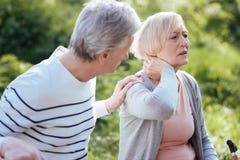 Distracted pensioner feeling terrible pain in the neck outdoors royalty free stock photos Distracted pensioner feeling terrible pain in the neck outdoors royalty free stock photos