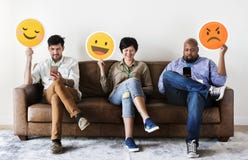 Diverse people sitting and holding emojis logos Stock Images Diverse people sitting and holding emojis logos Stock Images