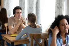Diverse young positive people sitting in cafe stock image Diverse young positive people sitting in cafe stock image