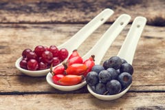 Diversity of berries on wood table. Vintage healthy food background
