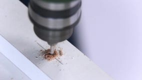 DIY-Huis Houten Meubilair Boorgaten in een witte spaanplaat die een elektrische boor gebruiken Macro close-up stock footage DIY-Huis Houten Meubilair Boorgaten in een witte spaanplaat die een elektrische boor gebruiken Macro close-up stock footage
