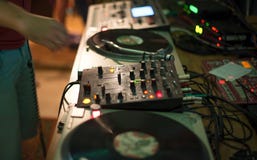 DJ mixer and record in a nightclub stock image DJ mixer and record in a nightclub stock image
