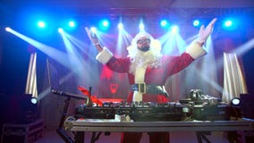 DJ Santa Claus mixing up some Christmas event.