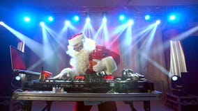 DJ Santa Claus mixing up some Christmas event.