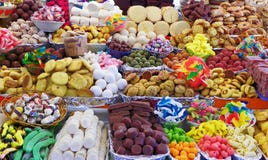 Doces tradicionais durante a celebração católica do Corpus Christi em suportes numerosos no mercado livre em Cuenca, Equador imagem de stock royalty free Doces tradicionais durante a celebração católica do Corpus Christi em suportes numerosos no mercado livre em Cuenca, Equador imagem de stock royalty free