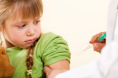 Doctor applying syringe to child - Pediatrician Stock Image Doctor applying syringe to child - Pediatrician Stock Image