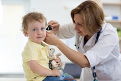 Doctor examines ear with otoscope in a pediatrician room. Medical equipment
