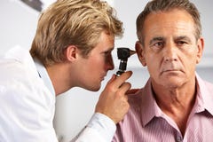 Doctor Examining Male Patient's Ears stock image Doctor Examining Male Patient's Ears stock image