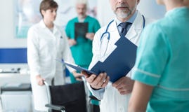 Doctor examining a patient`s medical records stock images Doctor examining a patient`s medical records stock images