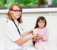 Doctor gives to drink to the sick child royalty free stock photo Doctor gives to drink to the sick child royalty free stock photo