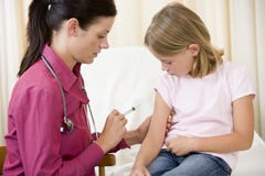 Doctor giving needle to young girl