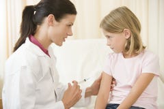 Doctor giving needle to young girl