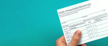 Doctor is holding COVID-19 vaccination record card, banner, concept of healthcare, copy space