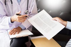Doctor informing patient`s of diagnosis medical record from pape royalty free stock photo Doctor informing patient`s of diagnosis medical record from pape royalty free stock photo