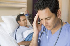 Doctor Looking Frustrated In Patients Room Stock Images Doctor Looking Frustrated In Patients Room Stock Images