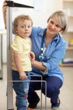 Doctor measuring boy`s height Stock Photo Doctor measuring boy`s height Stock Photo