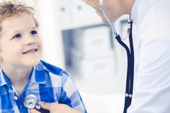 Doctor and patient child. Physician examining little boy. Regular medical visit in clinic. Medicine and health care stock photography Doctor and patient child. Physician examining little boy. Regular medical visit in clinic. Medicine and health care stock photography