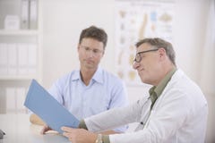 Doctor and patient discussing blood-test results stock photo Doctor and patient discussing blood-test results stock photo