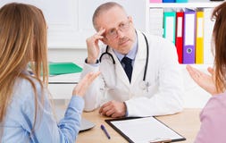 Doctor and patients discussing something in medical office . Medicine and health care concept. Doctor and patient royalty free stock images Doctor and patients discussing something in medical office . Medicine and health care concept. Doctor and patient royalty free stock images