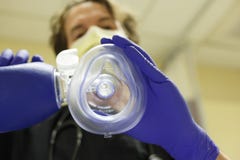 Doctor placing a breathing mask royalty free stock photos Doctor placing a breathing mask royalty free stock photos