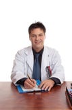 Doctor que se sienta en el escritorio foto de archivo Doctor que se sienta en el escritorio foto de archivo