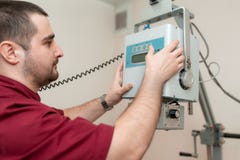 The doctor radiologist sets up an old veterinary X-ray machine before work at a veterinary hospital stock photo The doctor radiologist sets up an old veterinary X-ray machine before work at a veterinary hospital stock photo