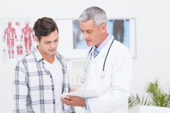 Doctor showing clipboard to his patient stock photos Doctor showing clipboard to his patient stock photos