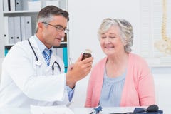 Doctor Showing Medicine Bottle To Female Patient Royalty Free Stock Image Doctor Showing Medicine Bottle To Female Patient Royalty Free Stock Image