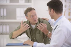 Doctor talking to frightened patient