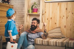 Doctor talking to happy patient, recovery from disease, successful treatment, health concept. Father and son playing stock photos Doctor talking to happy patient, recovery from disease, successful treatment, health concept. Father and son playing stock photos