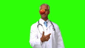 Doctor throwing an apple on green screen