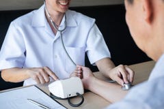 Doctor using a measuring blood pressure checking patient with examining, presenting results symptom and recommend treatment method royalty free stock photography Doctor using a measuring blood pressure checking patient with examining, presenting results symptom and recommend treatment method royalty free stock photography