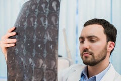 Doctor viewing MRI scans at his office royalty free stock photography Doctor viewing MRI scans at his office royalty free stock photography