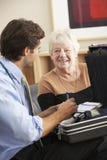 Doctor visiting senior woman at home stock photo Doctor visiting senior woman at home stock photo