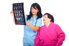 Doctor woman review MRI with her elderly patient royalty free stock photography Doctor woman review MRI with her elderly patient royalty free stock photography