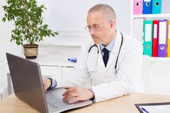 Doctor works at the computer in his office in clinic royalty free stock image Doctor works at the computer in his office in clinic royalty free stock image