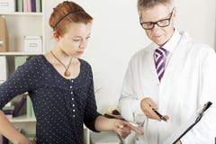 Doctor with young female patient woman royalty free stock photos Doctor with young female patient woman royalty free stock photos