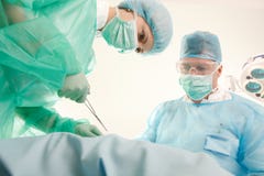 Doctors operating patient