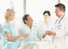 Doctors Talking To Old Patient In Hospital Stock Photography Doctors Talking To Old Patient In Hospital Stock Photography