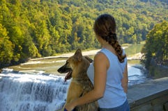 Dog And Girl At The Waterfall Stock Images
