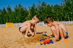 Dois meninos que jogam na areia foto de stock Dois meninos que jogam na areia foto de stock