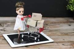 Doll is currently shopping,E-commerce and delivery service concept royalty free stock image Doll is currently shopping,E-commerce and delivery service concept royalty free stock image
