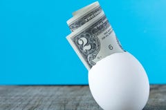 2 dollar bill in an egg shell. On a turquoise background. The co royalty free stock photo 2 dollar bill in an egg shell. On a turquoise background. The co royalty free stock photo