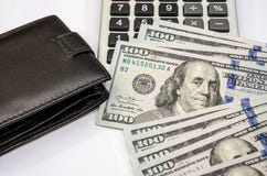 Dollars, calculator and black wallet on white royalty free stock photo Dollars, calculator and black wallet on white royalty free stock photo