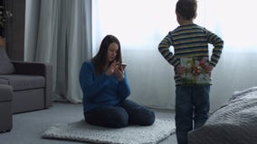 Donante del niño pequeño presente a su mamá el día del ` s de la madre Donante del niño pequeño presente a su mamá el día del ` s de la madre