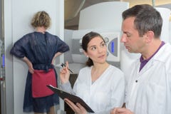 Donna che subisce ricerca di mammografia assistita da medici fotografia stock libera da diritti Donna che subisce ricerca di mammografia assistita da medici fotografia stock libera da diritti